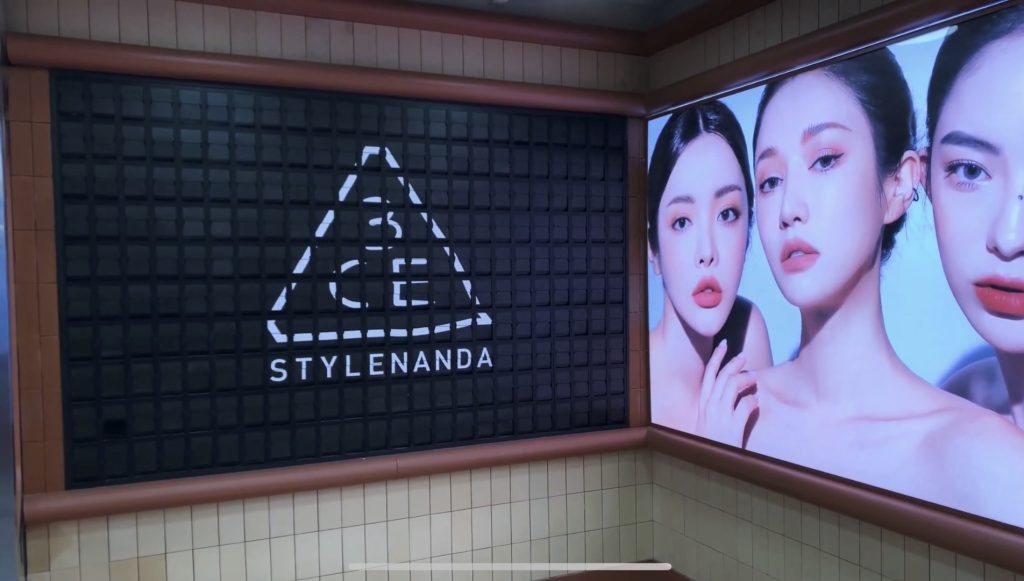 Custom split flap display with 3CE STYLENANDA logo in retail store