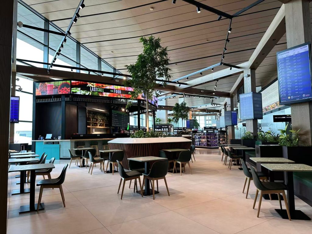 Interior view of LASTCALL airport restaurant at Hamad International Airport with custom split flap display and picture flap displays by TS Display