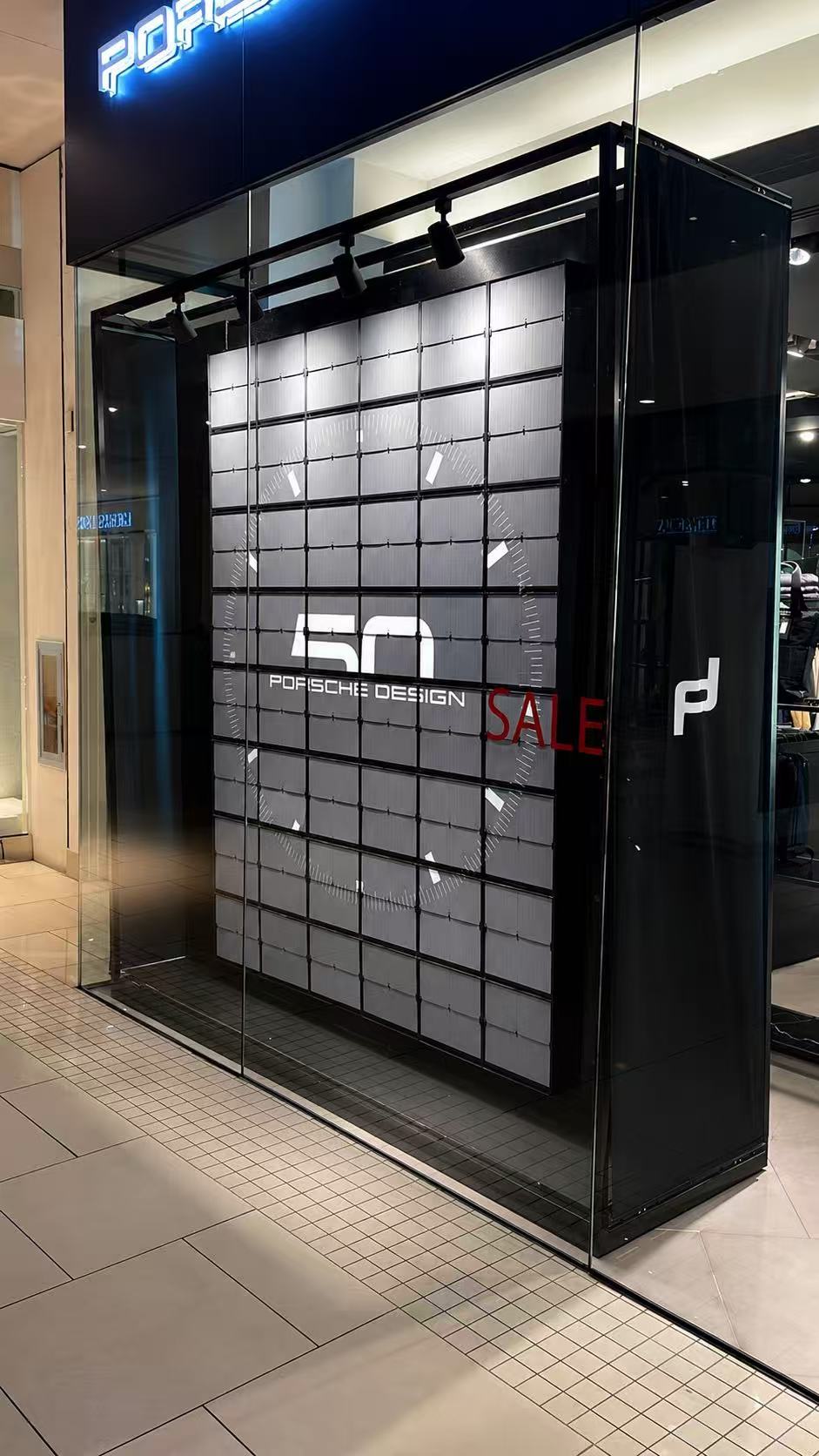 Picture Flap Display showing Porsche Design 50th anniversary graphics inside a retail store window