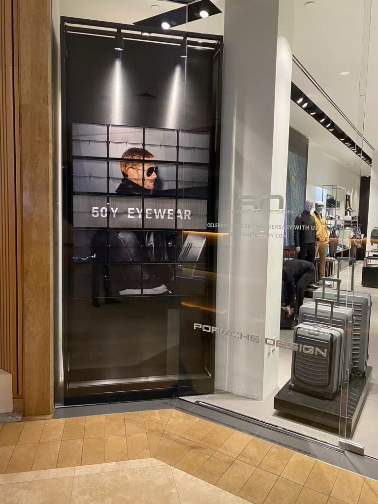 Porsche Design Picture Flap Display presenting the 50Y Eyewear campaign in a retail store window