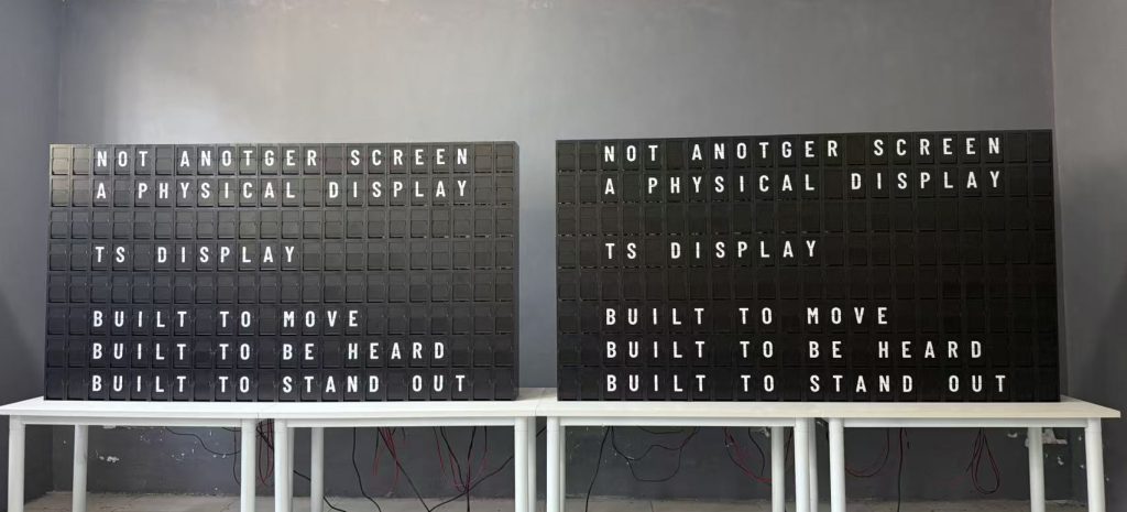 Two custom large split flap displays with mechanical flip lettering undergoing testing at the TS Display workshop.